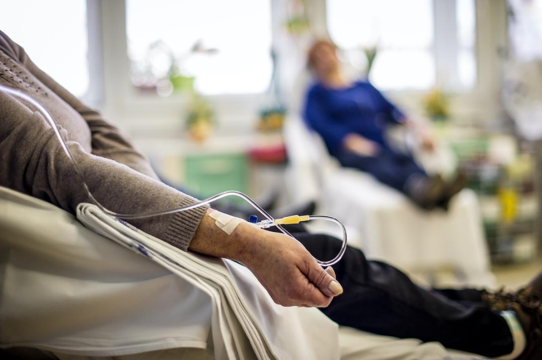 two women are pictured while receiving chemotherapy drugs in hospital